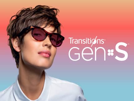 Woman wearing Transitions® Gen S™ glasses against a gradient background.